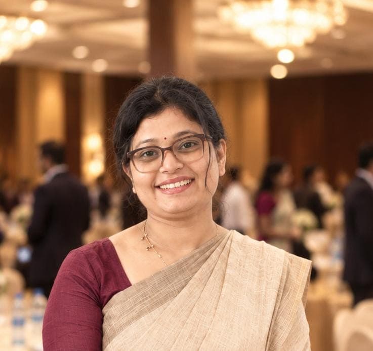 Swathi T P, Clinical Psychologist — smiling in a cream saree at a professional event